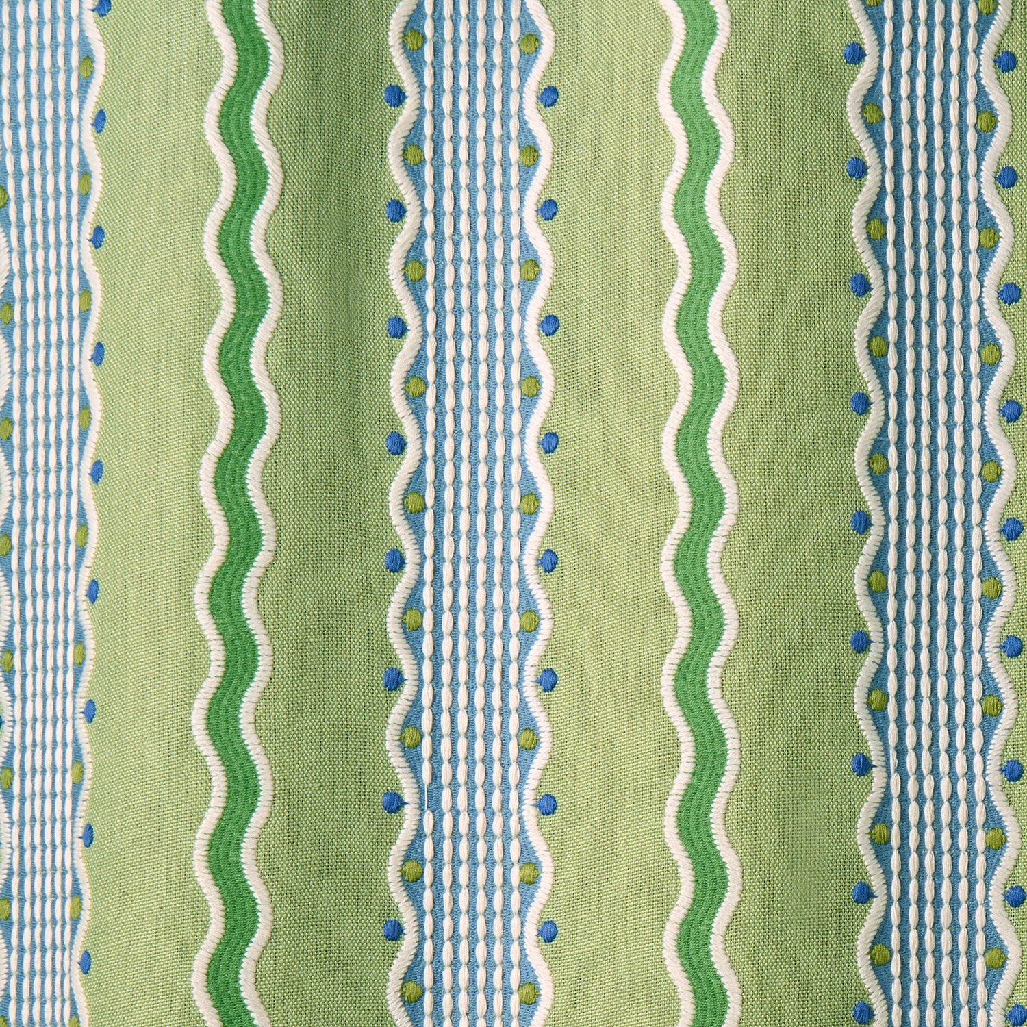 Embroidery fabric with green, blue, and white stripes on a green background.