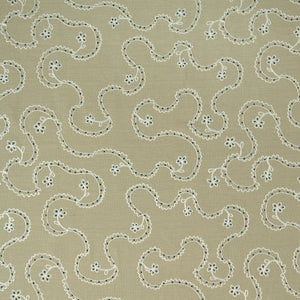 White embroidery pattern on a taupe background.