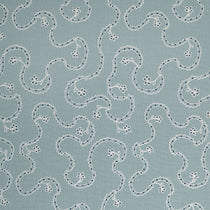 White embroidery pattern on a blue background.
