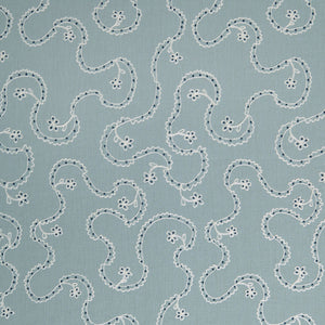White embroidery pattern on a blue background.