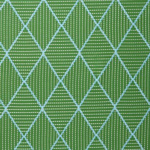 Geometric embroidery pattern with green and blue lines on a green background.