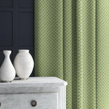 Curtain in green and off-white woven fabric featuring a trellis pattern.