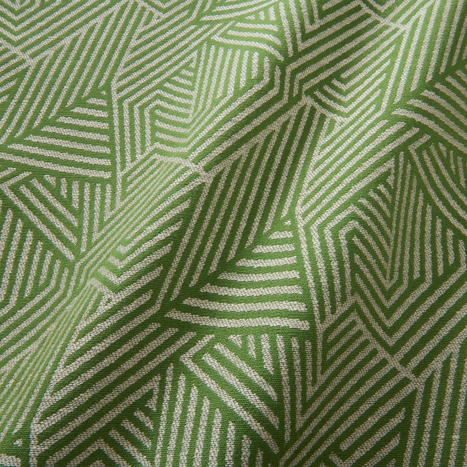 A woven fabric sample in green and off-white featuring a geometric pattern.