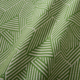 A woven fabric sample in green and off-white featuring a geometric pattern.