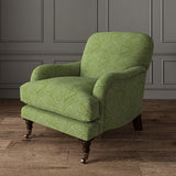 Chair upholstered in a green and off-white woven fabric featuring a geometric pattern.