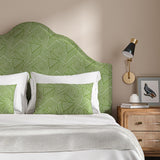 Headboard upholstered in a green and off-white woven fabric featuring a geometric pattern.