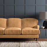 Sofa upholstered in a orange and off-white woven fabric featuring a geometric pattern.
