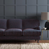 Sofa upholstered in a blue and red woven fabric featuring a wavy pattern.