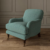 Chair upholstered in a blue and off-white woven fabric featuring a wavy pattern.