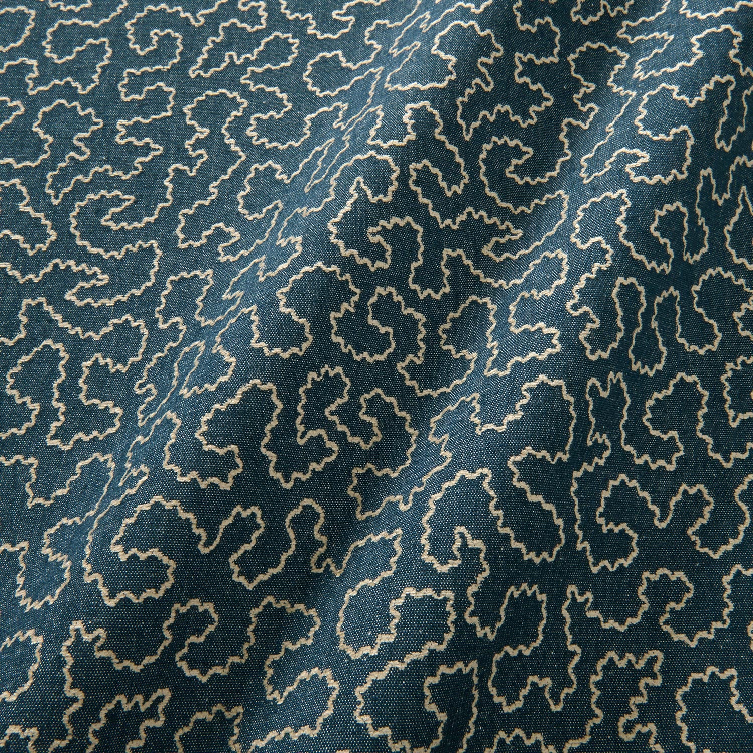 A woven fabric sample in blue and off-white featuring a wavy pattern.