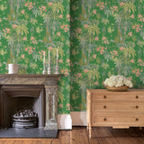 Sitting room with a tropical wallpaper in emerald green with exotic, floral blossoms intertwined with bamboo.