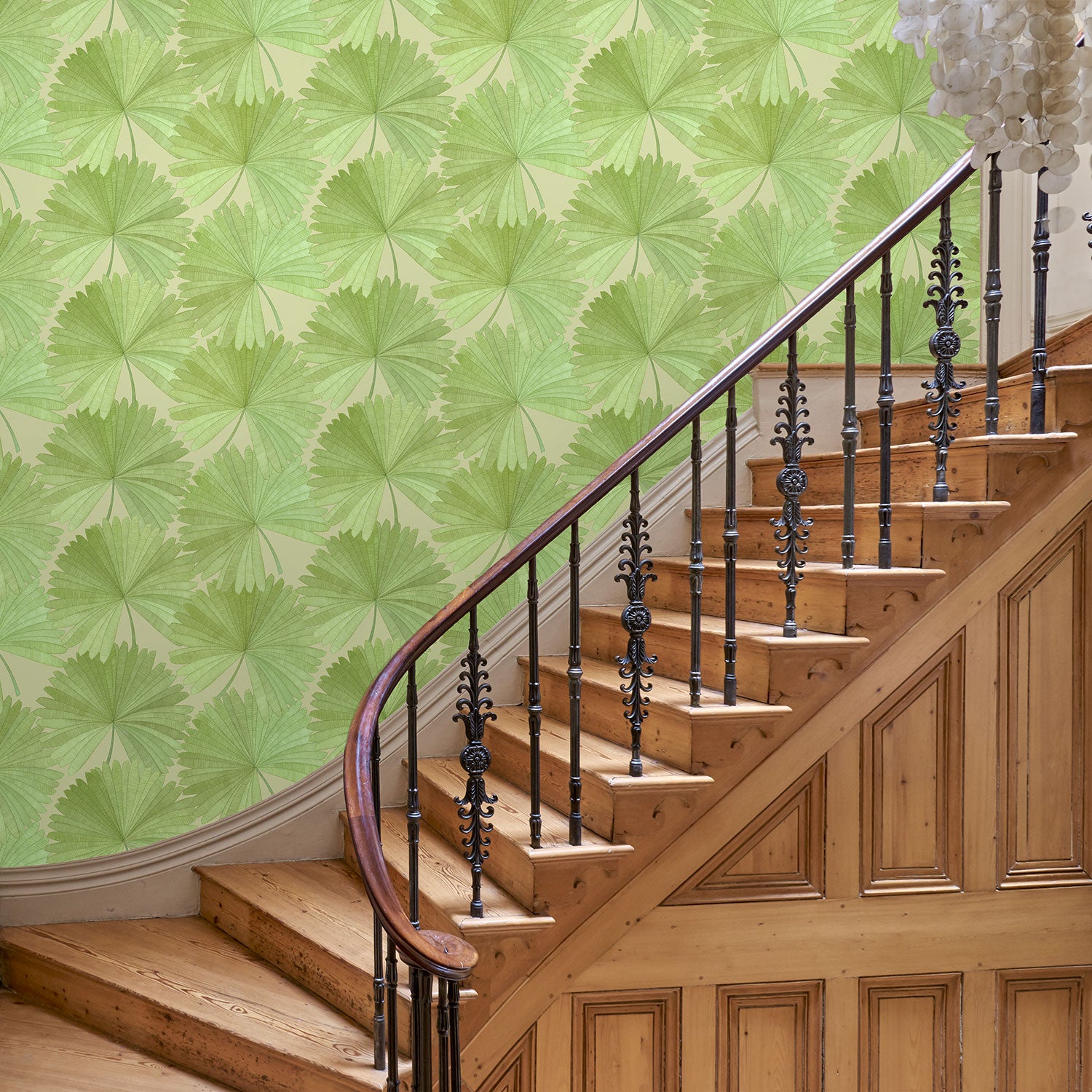 Hallway showing a contemporary floral wallpaper with tropical palms in fresh greens.