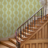 Luxurious wallpaper featuring stylised ferns and wavy lines in yellow and blue.