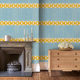 Sitting room with a chain-link wallpaper with different-sized blue and yellow stripes.