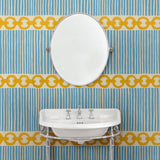 Cloakroom with a chain-link wallpaper with different-sized blue and yellow stripes.