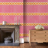 Sitting room with a chain-link wallpaper with different-sized orange and pink stripes.