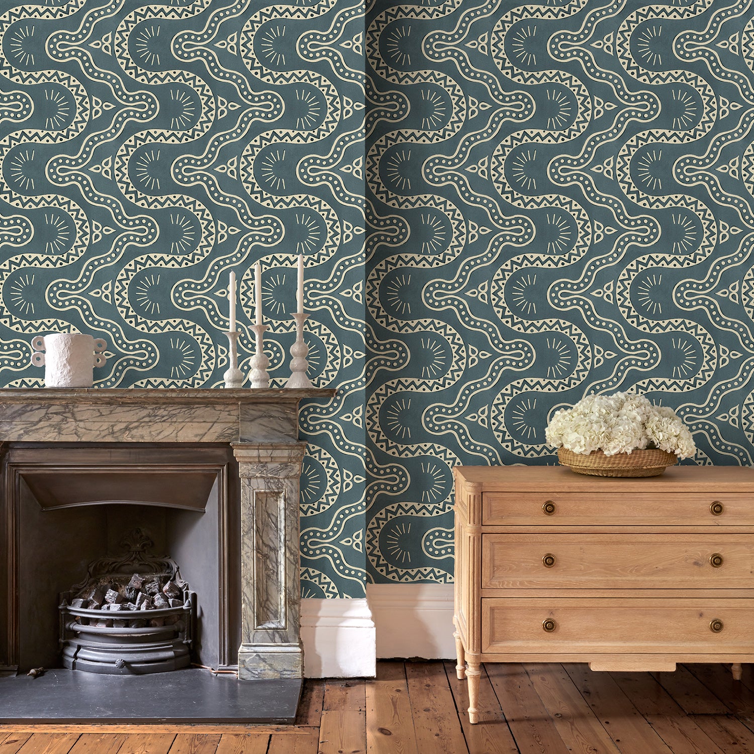 Sitting room with a blue geometric wallpaper.