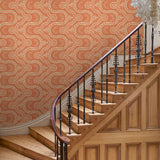 Hall with a orange geometric wallpaper.