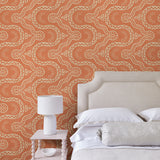 Bedroom with a orange geometric wallpaper.