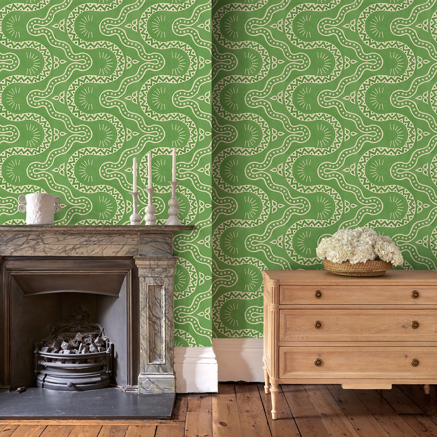 Sitting room with a green geometric wallpaper.