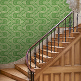 Hall with a green geometric wallpaper.
