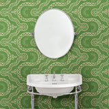 Cloakoom with a green geometric wallpaper.