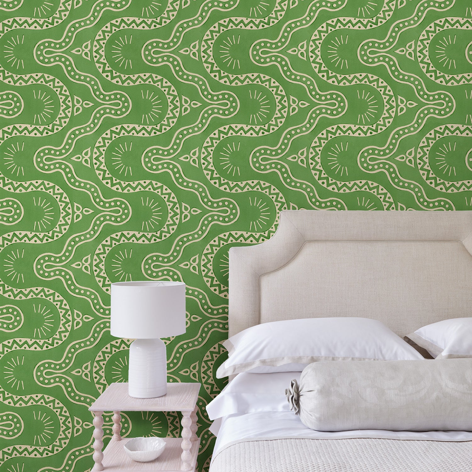 Bedroom with a green geometric wallpaper.