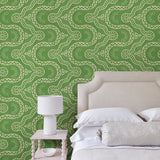 Bedroom with a green geometric wallpaper.