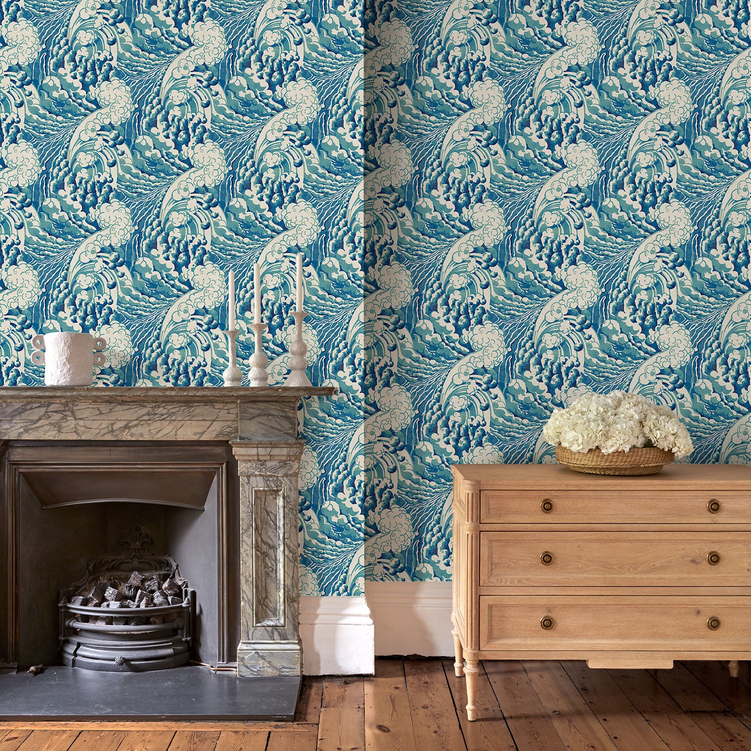 Sitting room with stylish abstract wallpaper featuring dramatic, undulating waves.