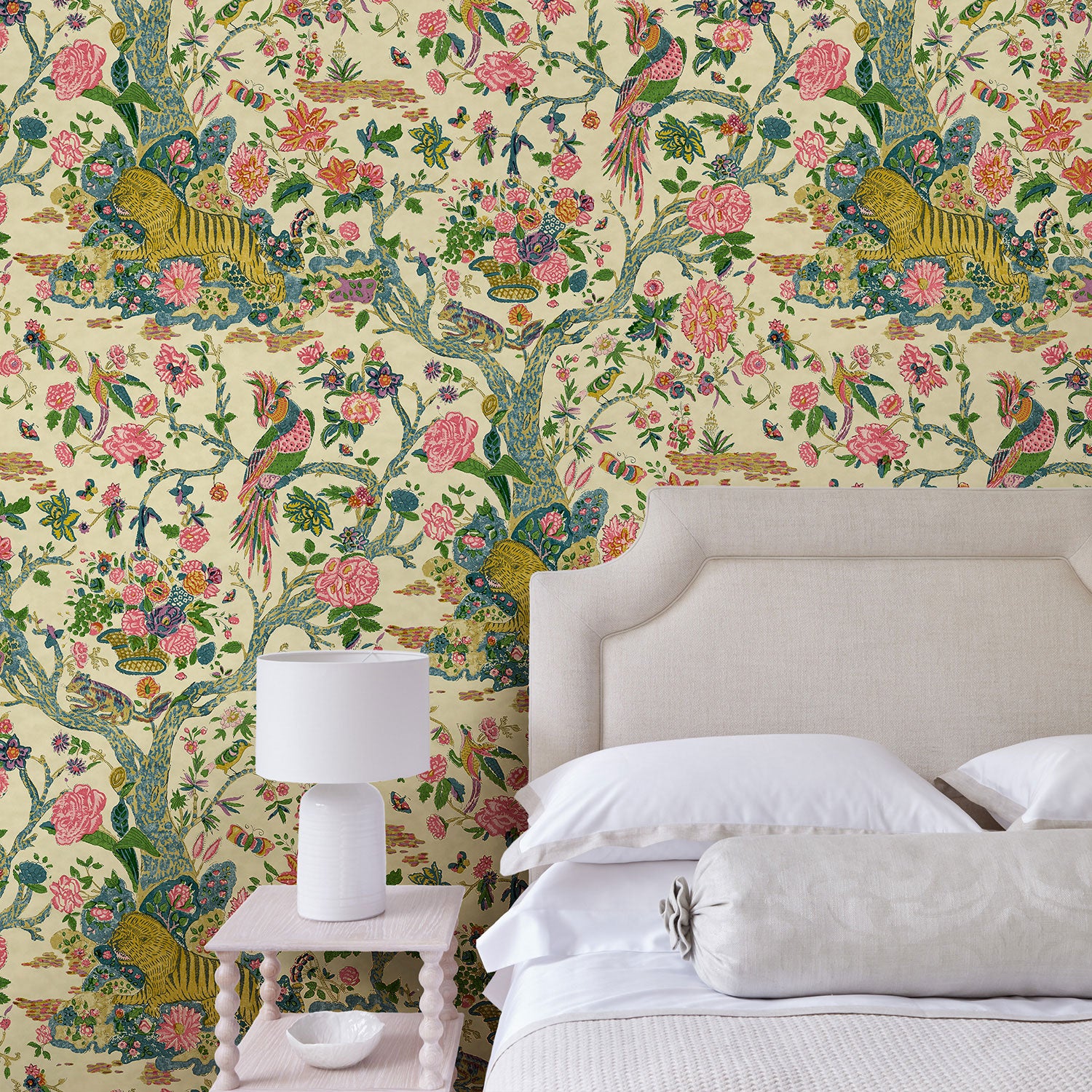 Presented in a fresh, inviting colour palette, this designer wallpaper features parrots, lions and exotic flowers.