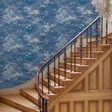 Hall featuring a painterly-style blue wallpaper.