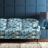 Sofa covered in a printed velvet fabric featuring a classic oak leaf design in Cornflower.