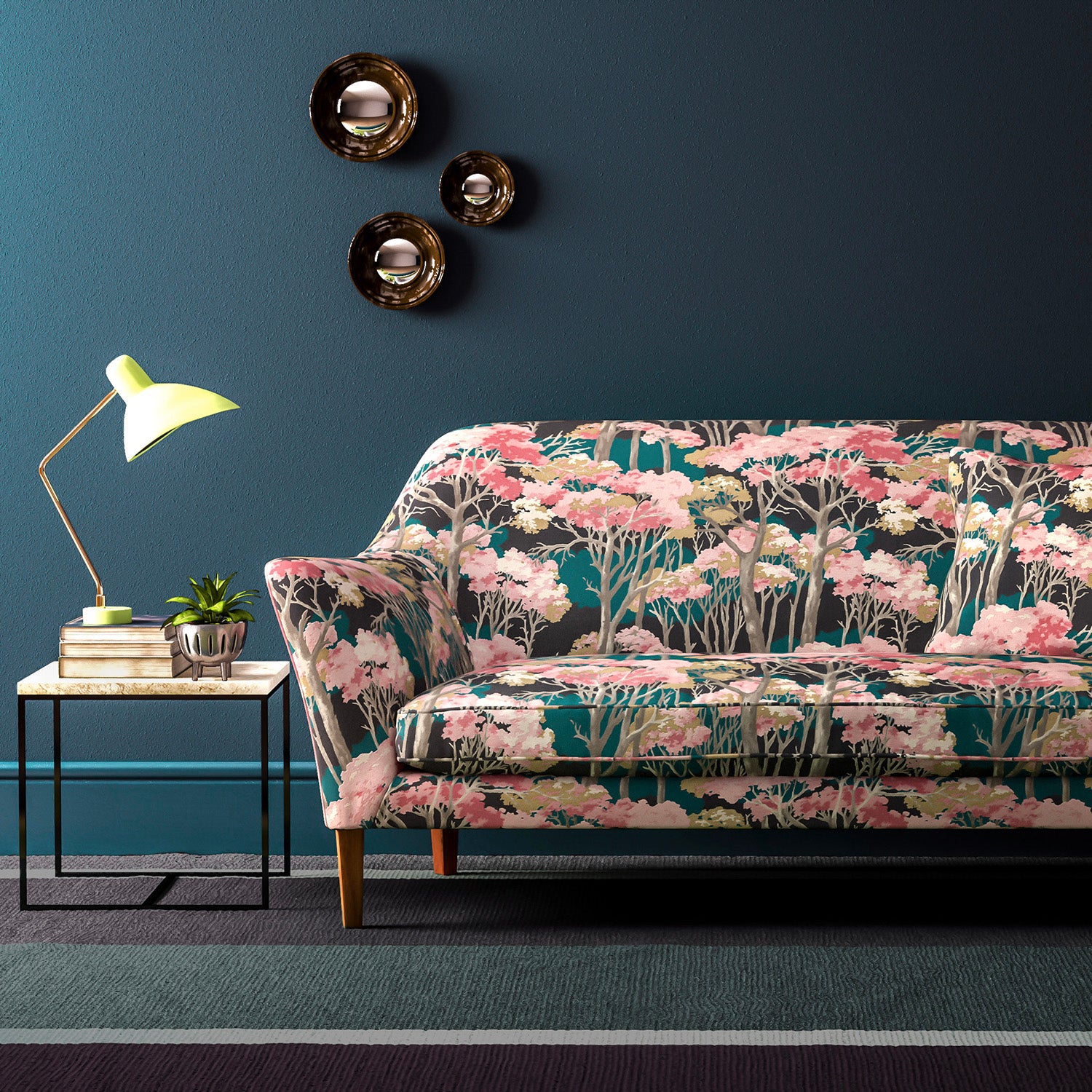 Sofa covered in a printed velvet upholstery fabric showcasing a pink Japanese tree design.