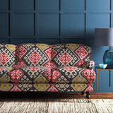Sofa upholstered in a henna velvet upholstery fabric with a kilim design with a stain resistant finish.