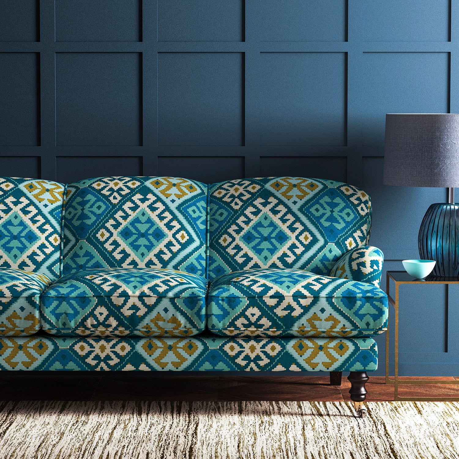 Sofa upholstered in a blue velvet upholstery fabric with a kilim design with a stain resistant finish.