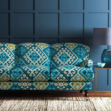 Sofa upholstered in a blue velvet upholstery fabric with a kilim design with a stain resistant finish.