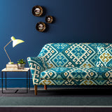 Sofa upholstered in a blue velvet upholstery fabric with a kilim design with a stain resistant finish.