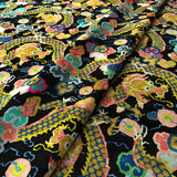 Printed velvet fabric with intricate mirror dragon design in multicolours, for upholstery and curtain use.