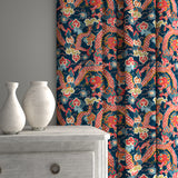 Velvet curtains upholstered in a printed velvet fabric with a intricate mirror dragon design in blue and orange colours.