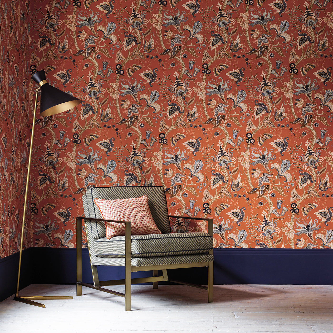 Sitting room with a tropical wallpaper in chilli showcasing beautiful botanicals and butterflies.