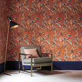 Sitting room with a tropical wallpaper in chilli showcasing beautiful botanicals and butterflies.