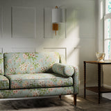 Sofa in a printed linen fabric with floral pattern. in blue, green and white colours.