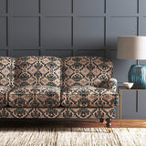 Velvet sofa upholstered in a printed velvet fabric with an oriental geometric design in multicolours