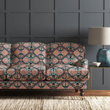 Velvet sofa upholstered in a printed velvet fabric with an oriental geometric design in vibrant colours