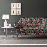 Velvet sofa upholstered in a printed velvet fabric with an oriental geometric design in vibrant colours