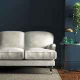 Sofa covered in a white velvet upholstery fabric