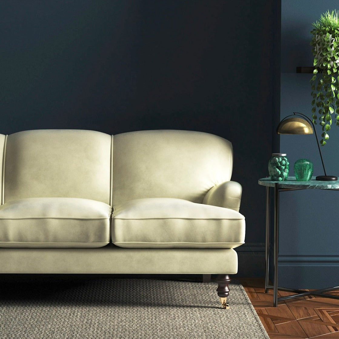 Sofa covered in a cream velvet upholstery fabric