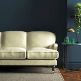 Sofa covered in a cream velvet upholstery fabric