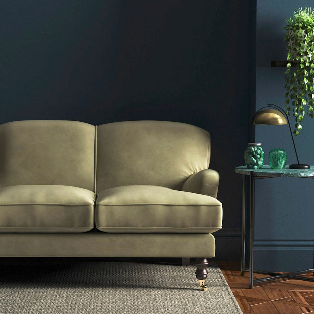 Sofa covered in a cream velvet upholstery fabric