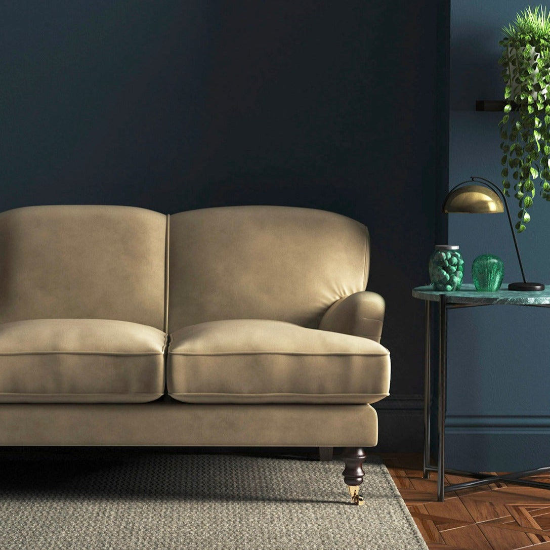 Sofa covered in a brown velvet upholstery fabric
